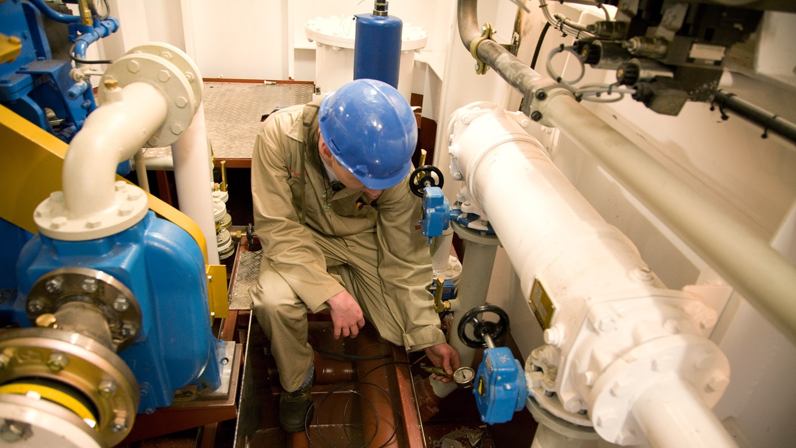 Mechanic inside vessel doing maintenance